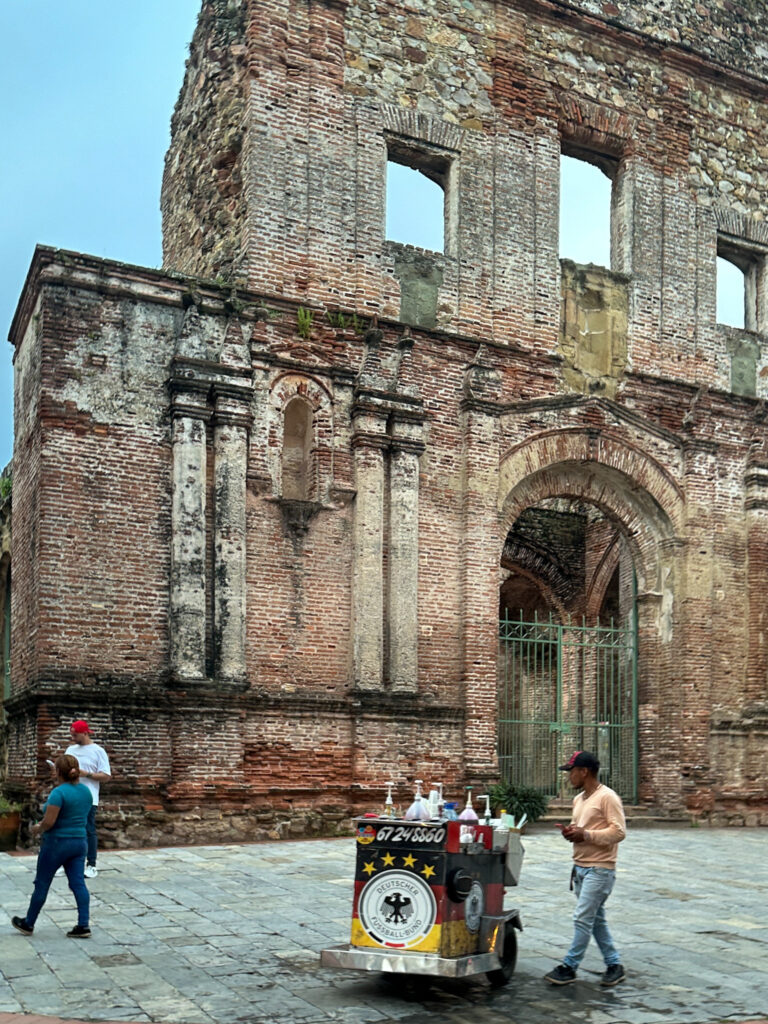 man with snow cone cart in front of Casco Viejo apartment rental and old Spanish ruins in Casco Viejo 