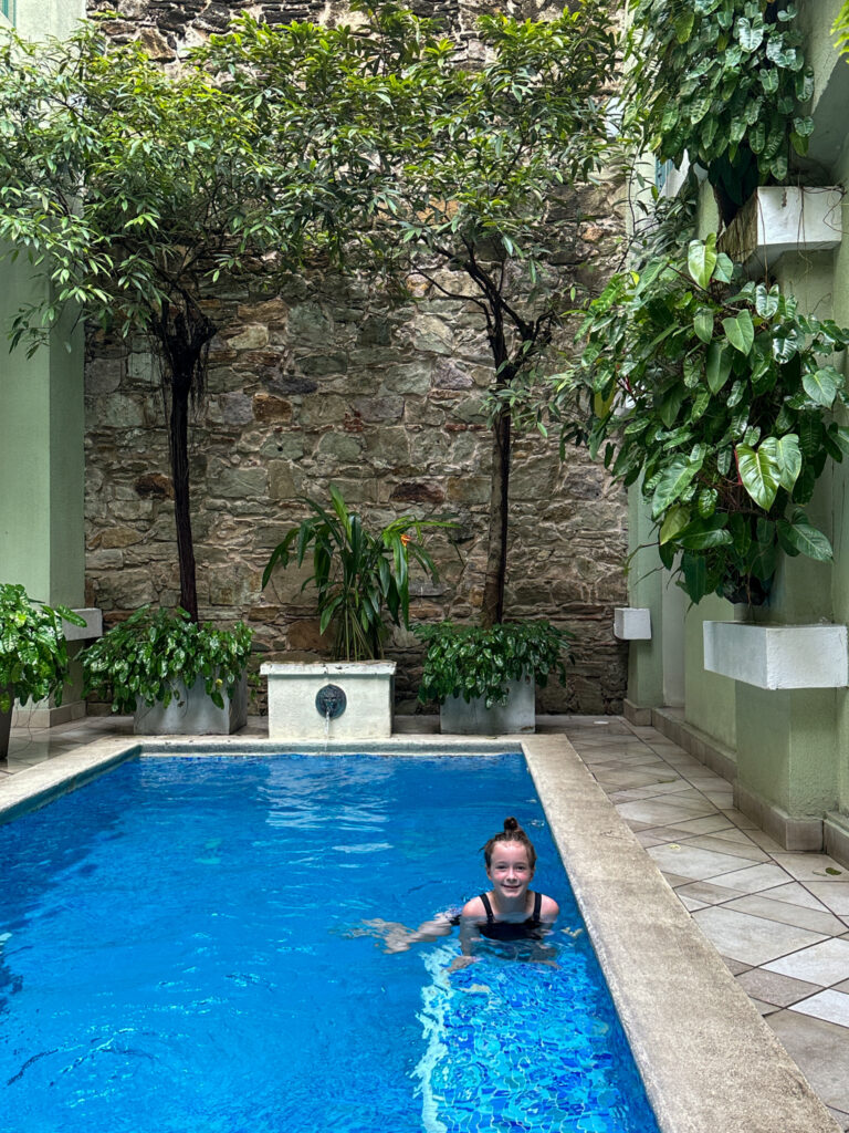 little girl in swimming pool at AmazINN Places Casco Viejo apartment hotel