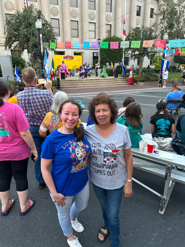 two women wearing Hispanic Heritage Month shirts at a Hispanic Heritage Month event in El Dorado, Arkansas