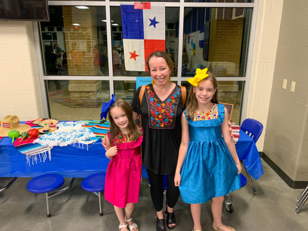 women and girls wearing Mexican embroidered outfits to Hispanic Heritage Month event