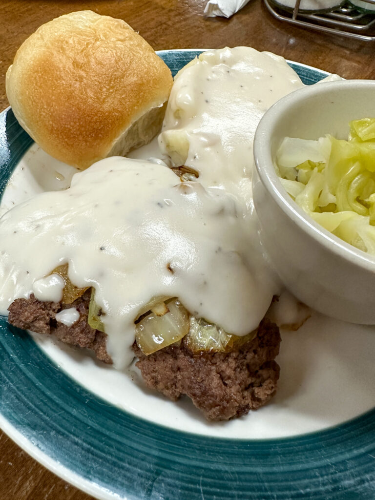 hamburger steak with white gravy on plate at Wagon Wheel Country Cafe in northwest Arkansas