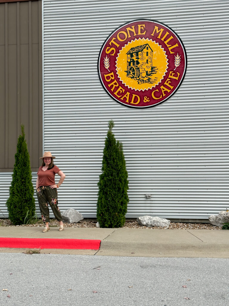 Arkansas blogger, Amy, stands in front of Stone Mille Bread and Cafe