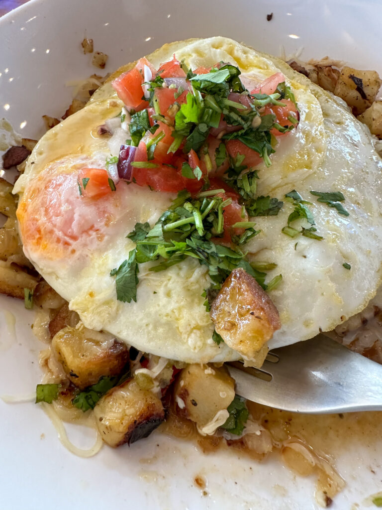 salsa verde pork and potato skillet with egg at HomeGrown in downtown Springdale