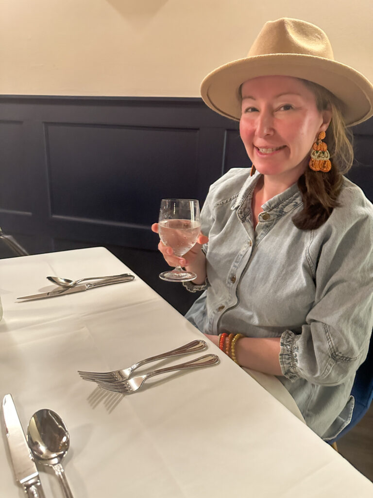 Arkansas lifestyle blogger, Amy, at table at Bienvenue Restaurant in downtown Springdale