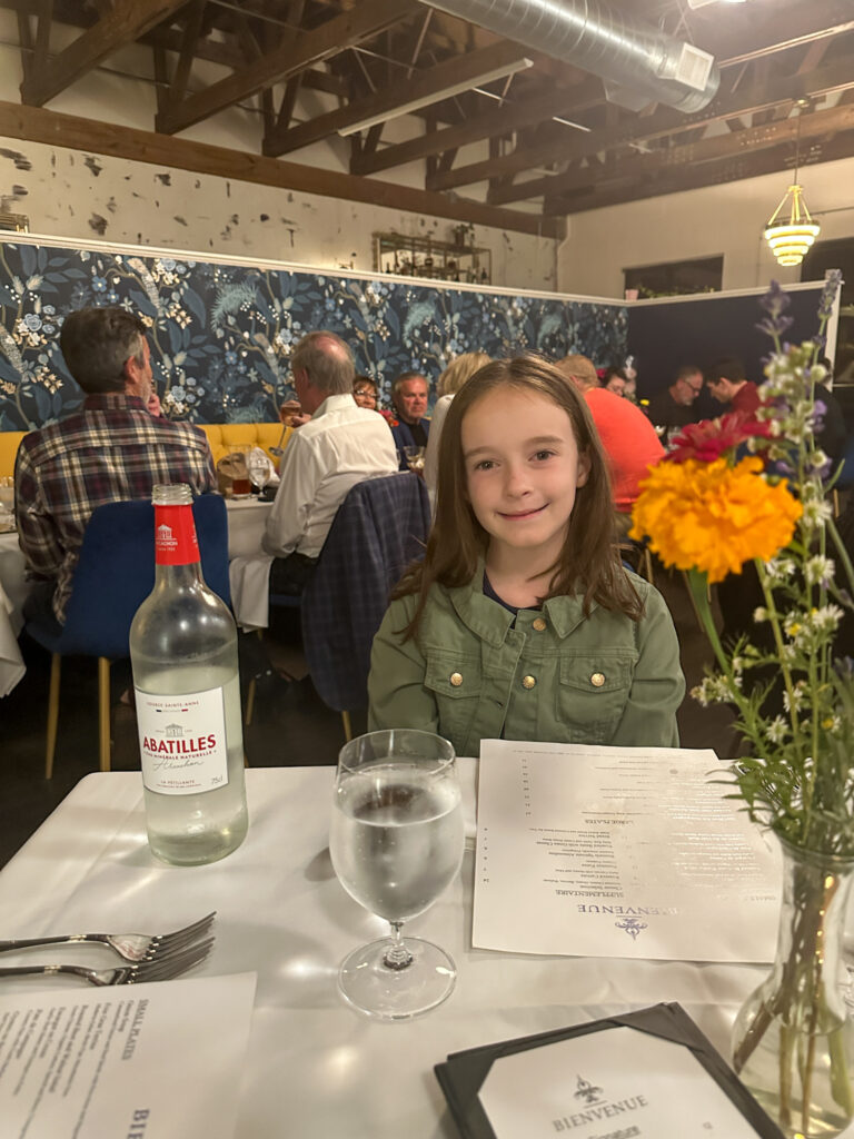 little girl at table at Bienvenue Restaurant in Springdale, Arkansas