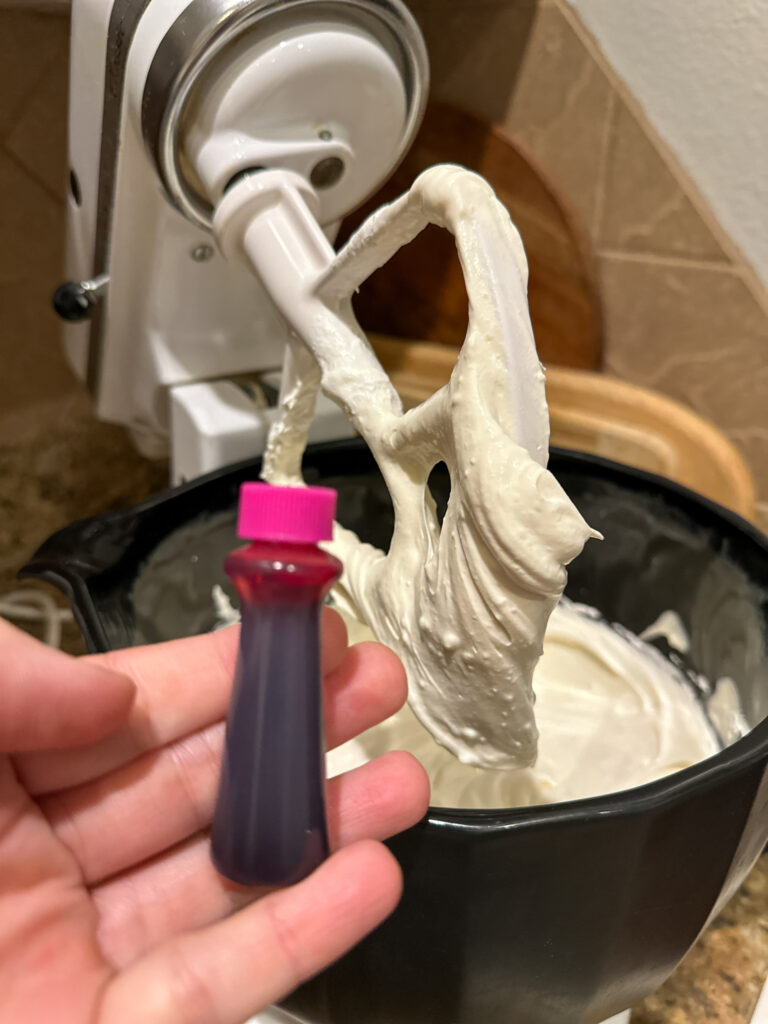 woman holds pink food coloring