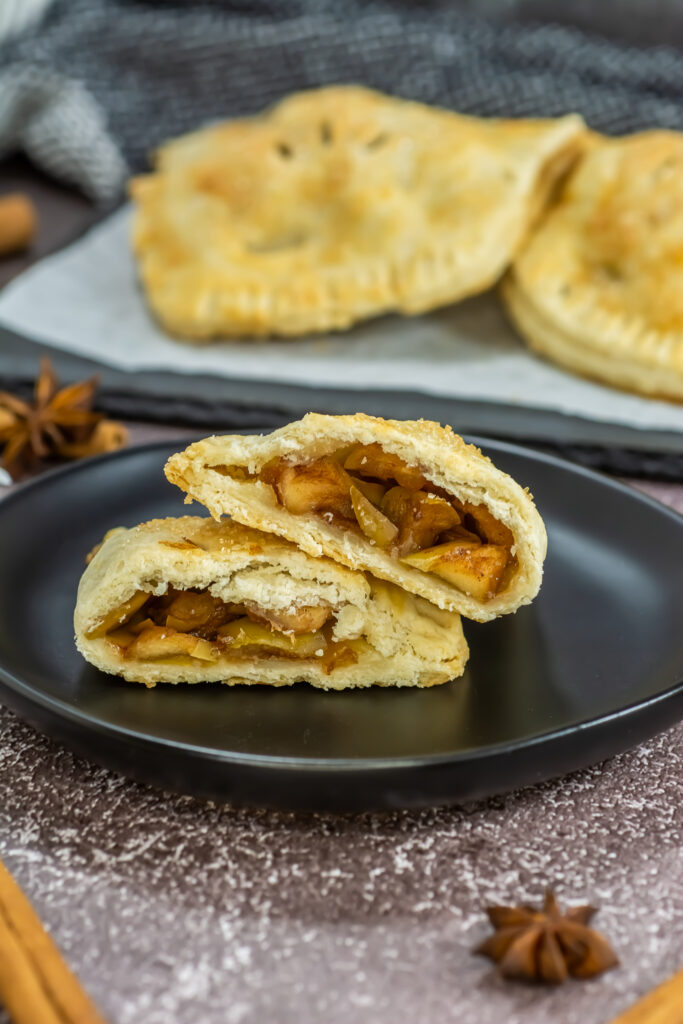 baked apple empanadas on black plate