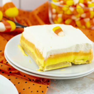 no bake candy corn lush on stack of white plates