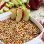 cream cheese caramel apple dip with peanuts on a party table with napkin