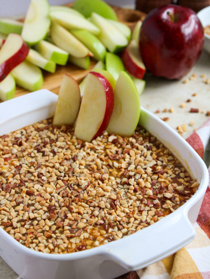 cream cheese caramel apple dip with peanuts on a party table with napkin