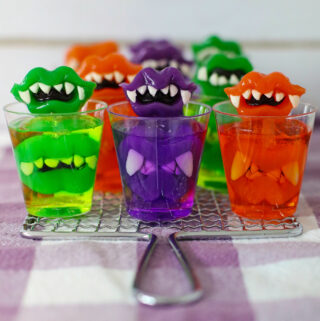 Halloween monster teeth Jello shots on plaid tablecloth