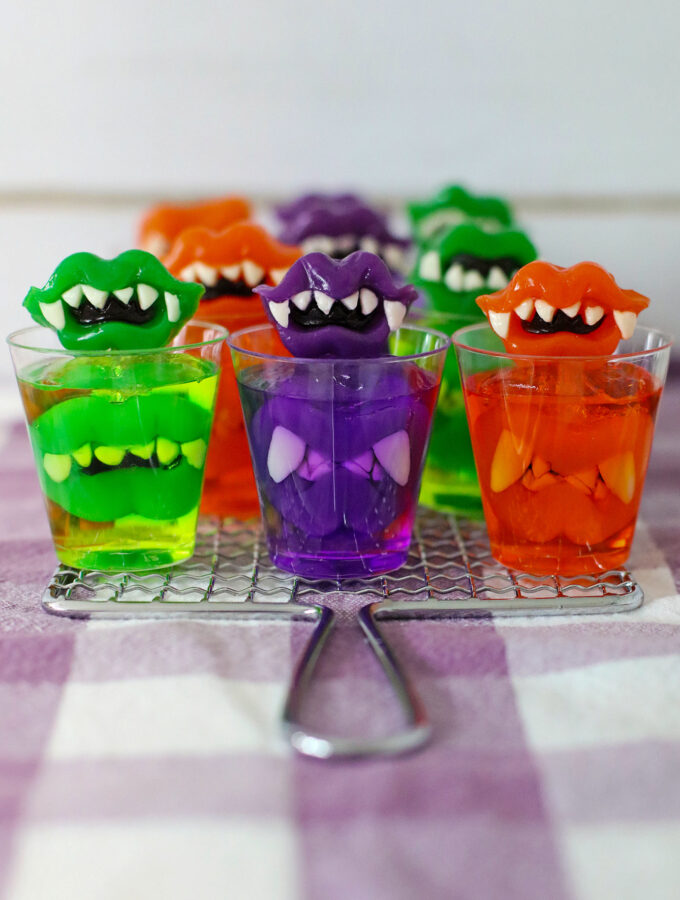 Halloween monster teeth Jello shots on plaid tablecloth