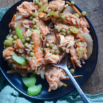 Panamanian arroz con pollo on plate with spoon and green napkin beside