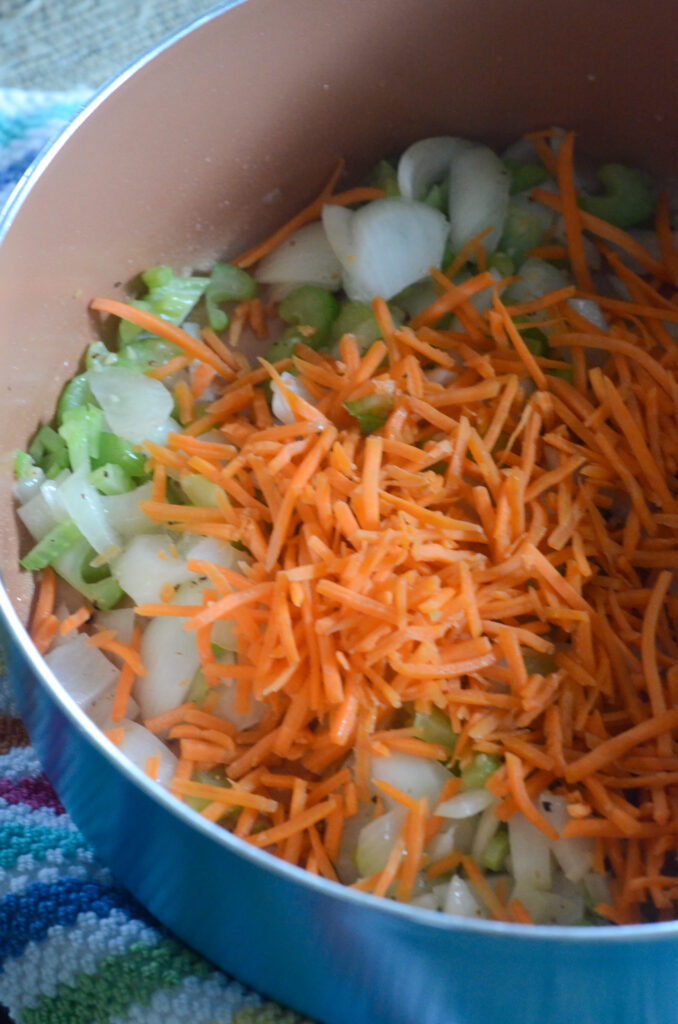 pot of veggies with carrots on top