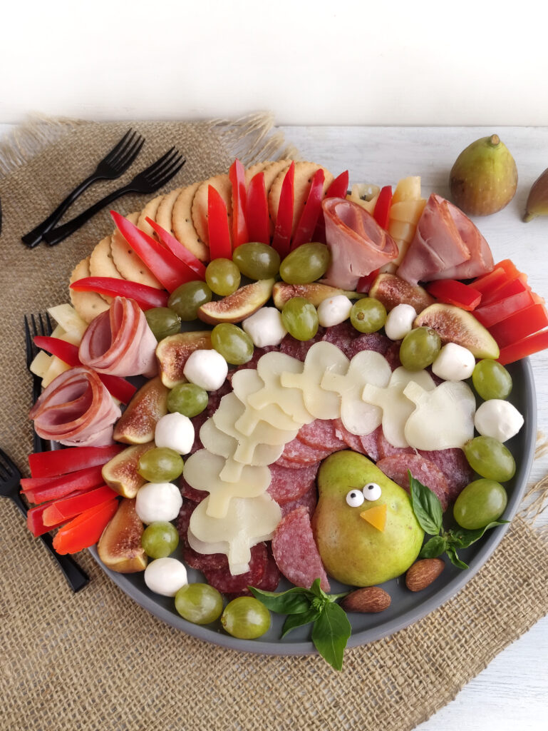 pear turkey charcuterie board for Thanksgiving on burlap cloth