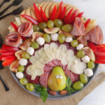 a Thanksgiving turkey meat and cheese tray with black forks