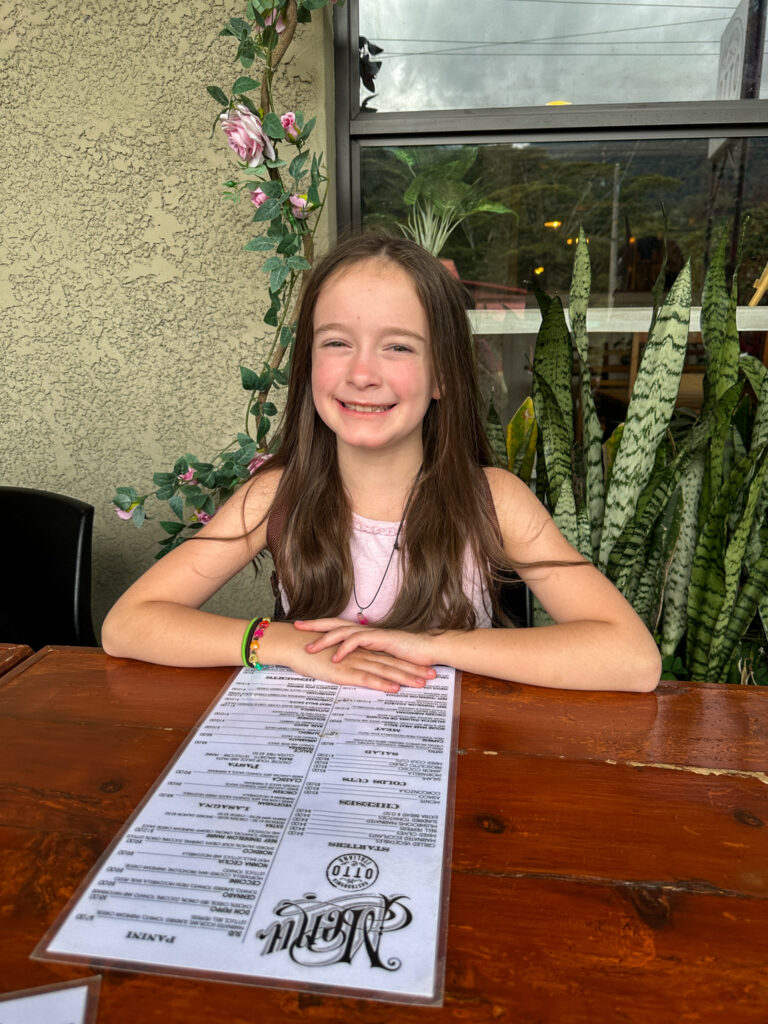 girl with menu at Otto Gastronomia Italiana Restaurant en Boquete Panama