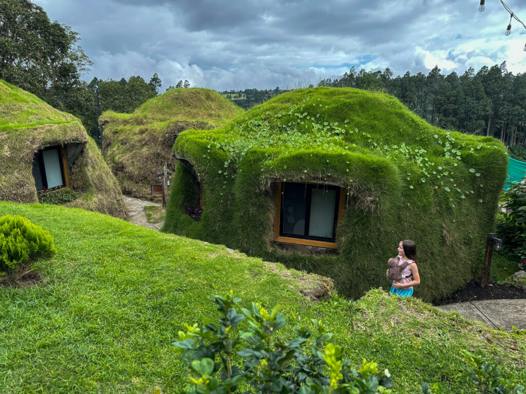 Arkansas blogger, Norah, walks in front of hobbit houses at Hotel Bermuda Castle in Boquete, Panama