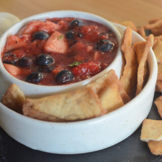 fruit salsa in white serving bowl with cinnamon pita chips