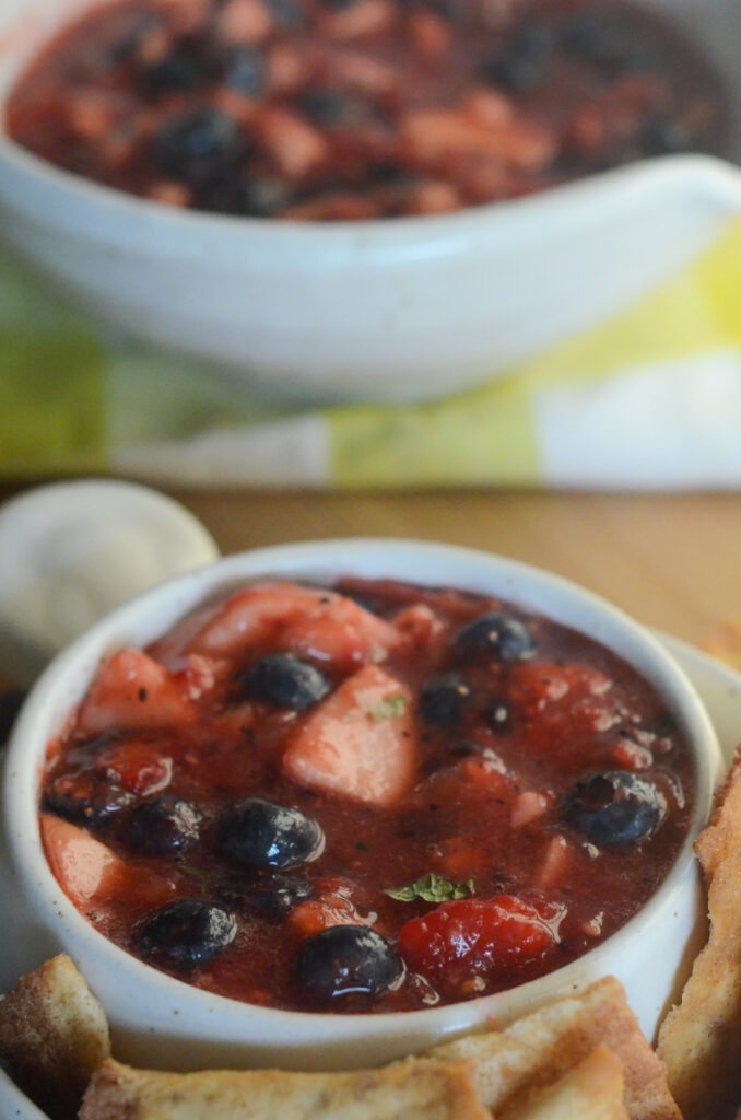 berry fruit salsa in white bowl with larger bowl at back