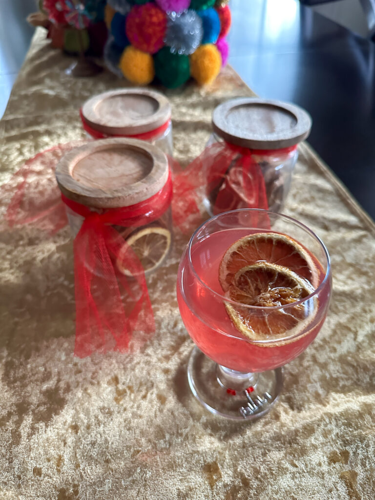 dehydrated fruit gifts in jars with some dried lemon slices in drink in front