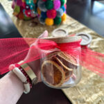 dehydrated fruit gifts in glass jar in woman's hand