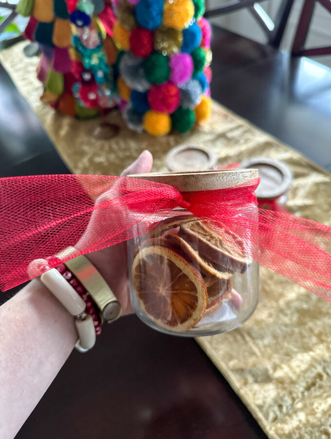 dehydrated fruit gifts in glass jar in woman's hand