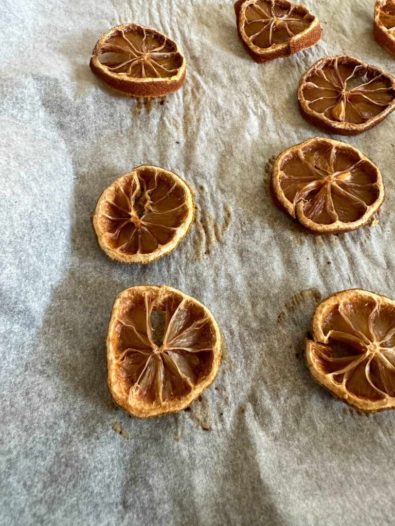 dehydrated lemon slices on parchment paper