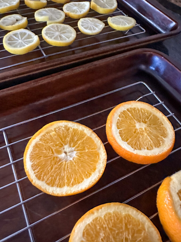 lemon wheels and orange wheels on baking racks for dehydrated fruit gifts for Christmas