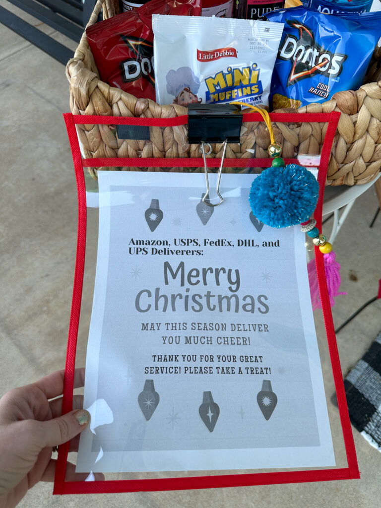 free printable delivery drivers treat sign on front porch in front of snack basket at Christmas