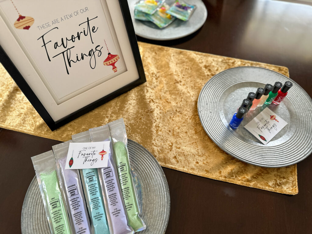 gifts set out on chargers at a Favorite Things party with free printables on table