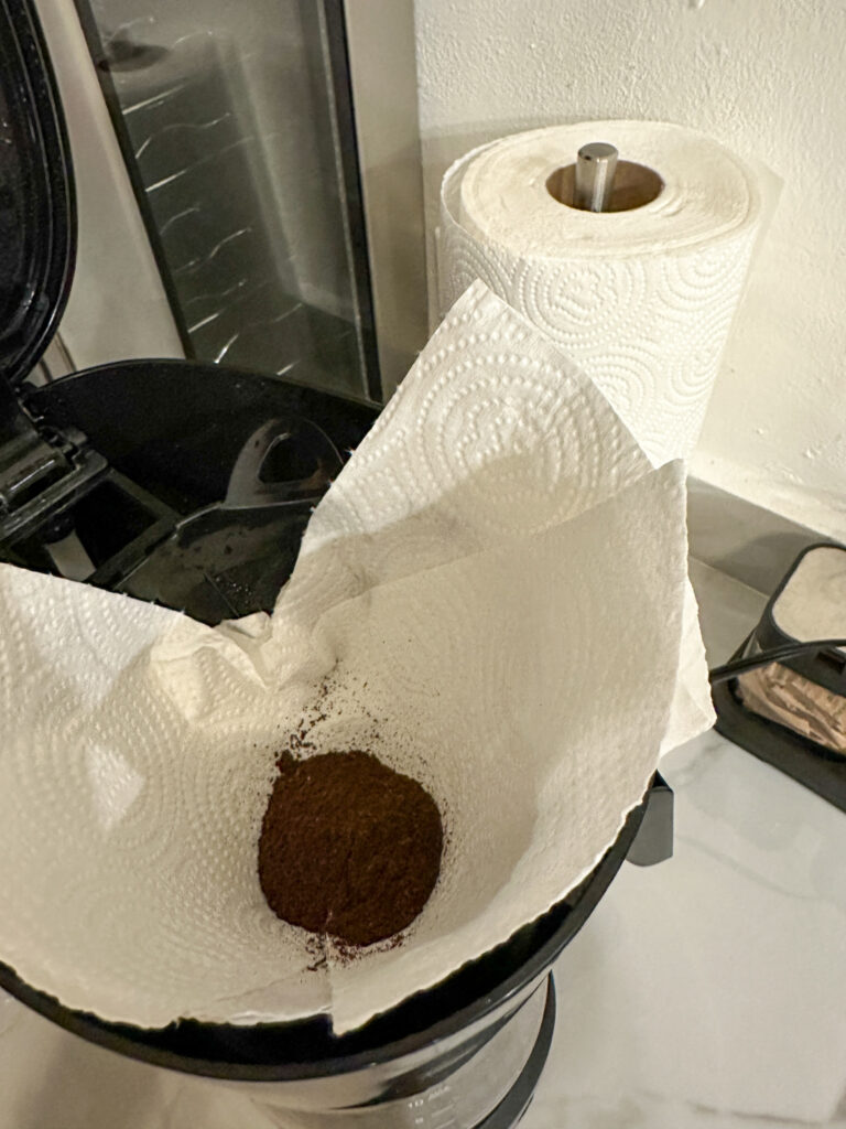 using a paper towel for a coffee filter with coffee grounds on top in Panama kitchen