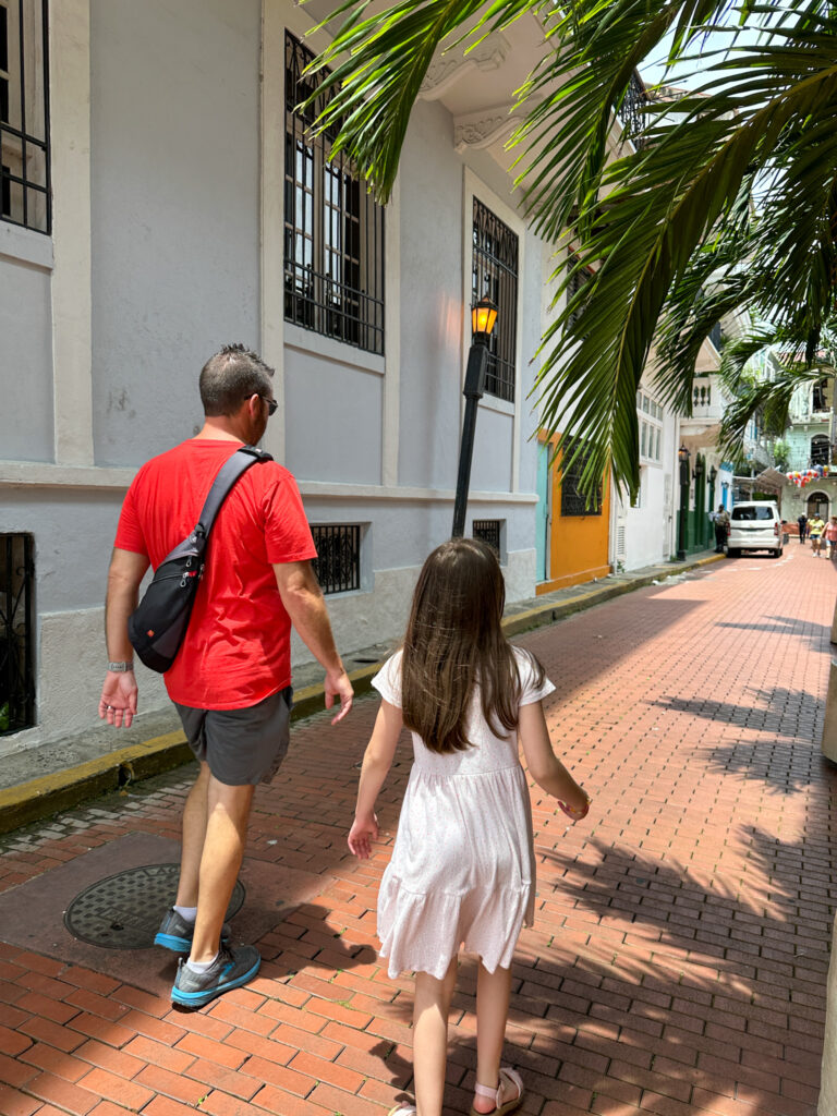 man and girl stroll along in Casco Viejo