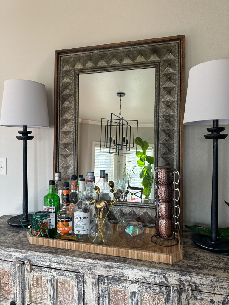 home bar on counter set up with printable cocktail of the month calendar