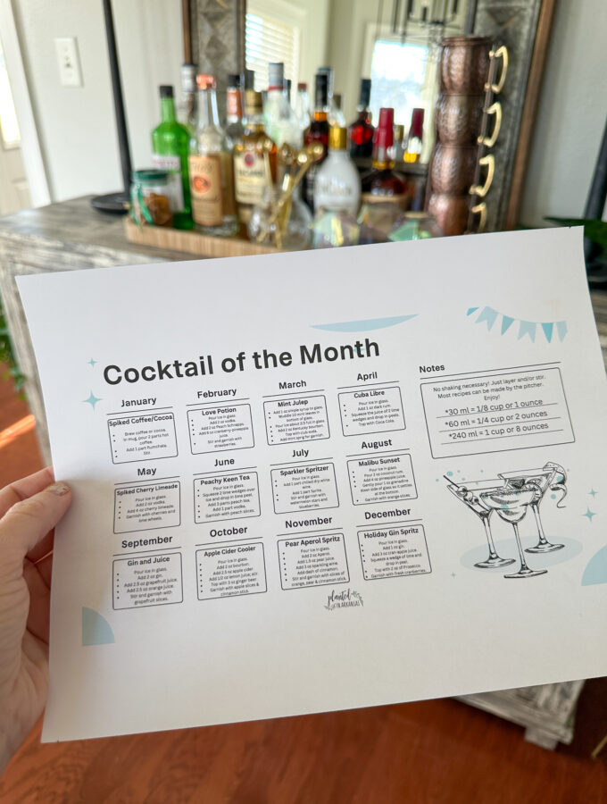 woman holds cocktail calendar of the month in hand