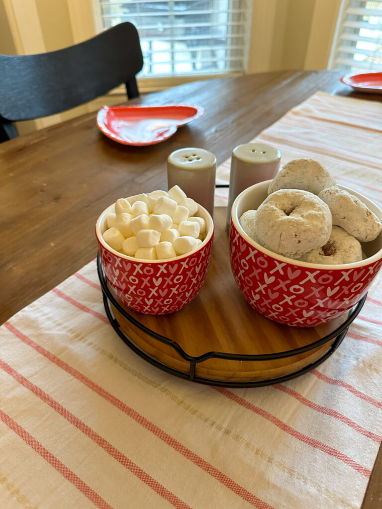 XOXO bowls of donuts and marshmallows on kitchen table for mom and me Galentine's Day brunch