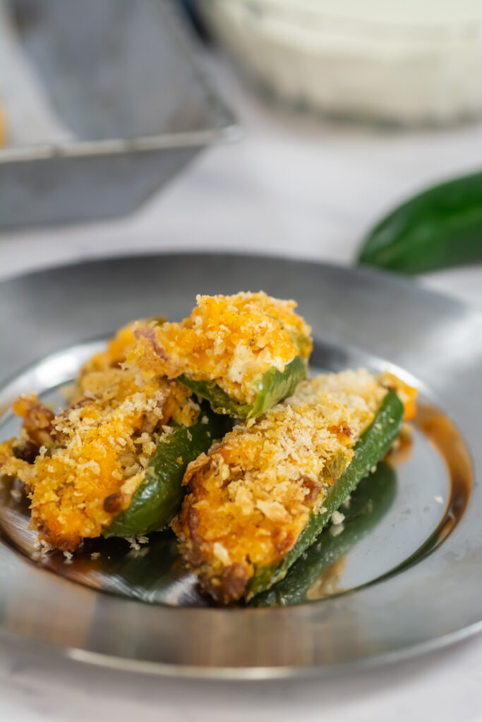 pile of air fried jalapeño cream cheese poppers on silver plate
