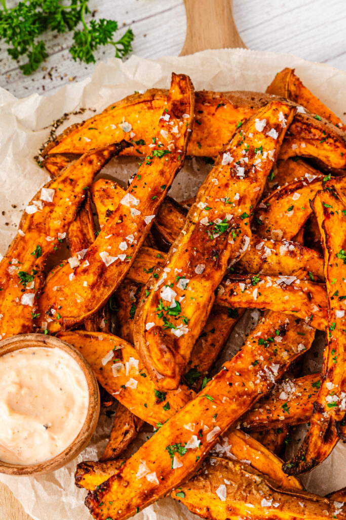 air fryer sweet potato wedges with a bowl of dipping sauce