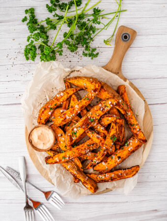 air fryer sweet potato wedges in an overhead photo with parsley
