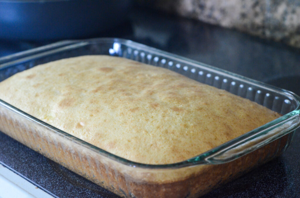 unfrosted cooling cake in glass pan