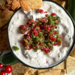 top down view of cranberry jalapeño dip with crackers on plate