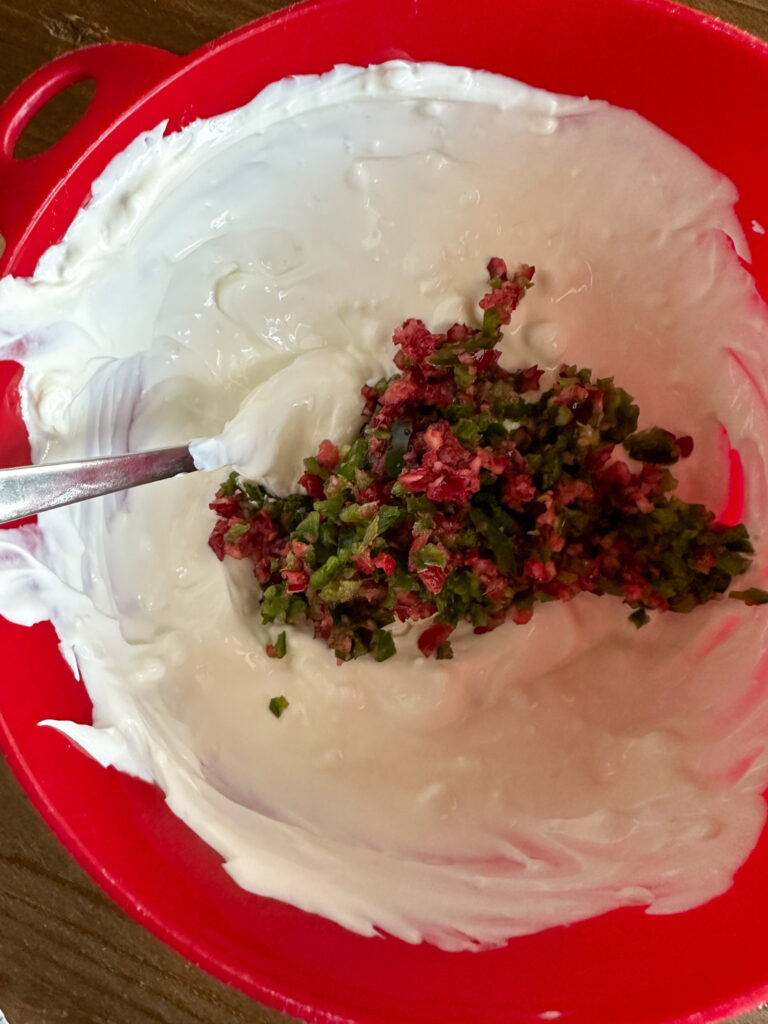 cream cheese with vegetable mixture in bowl