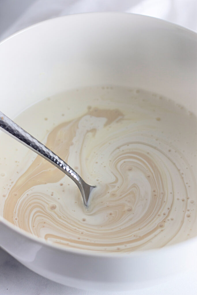 cream swirled in a bowl with a spoon