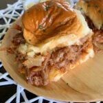 pineapple pulled pork sliders on bamboo platter