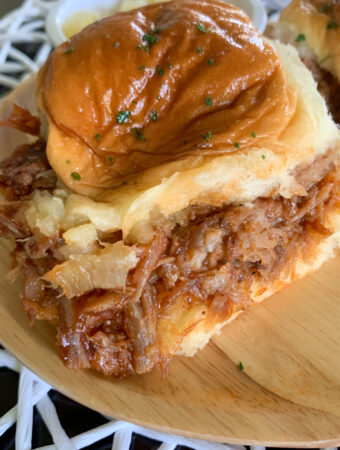 pineapple pulled pork sliders on bamboo platter