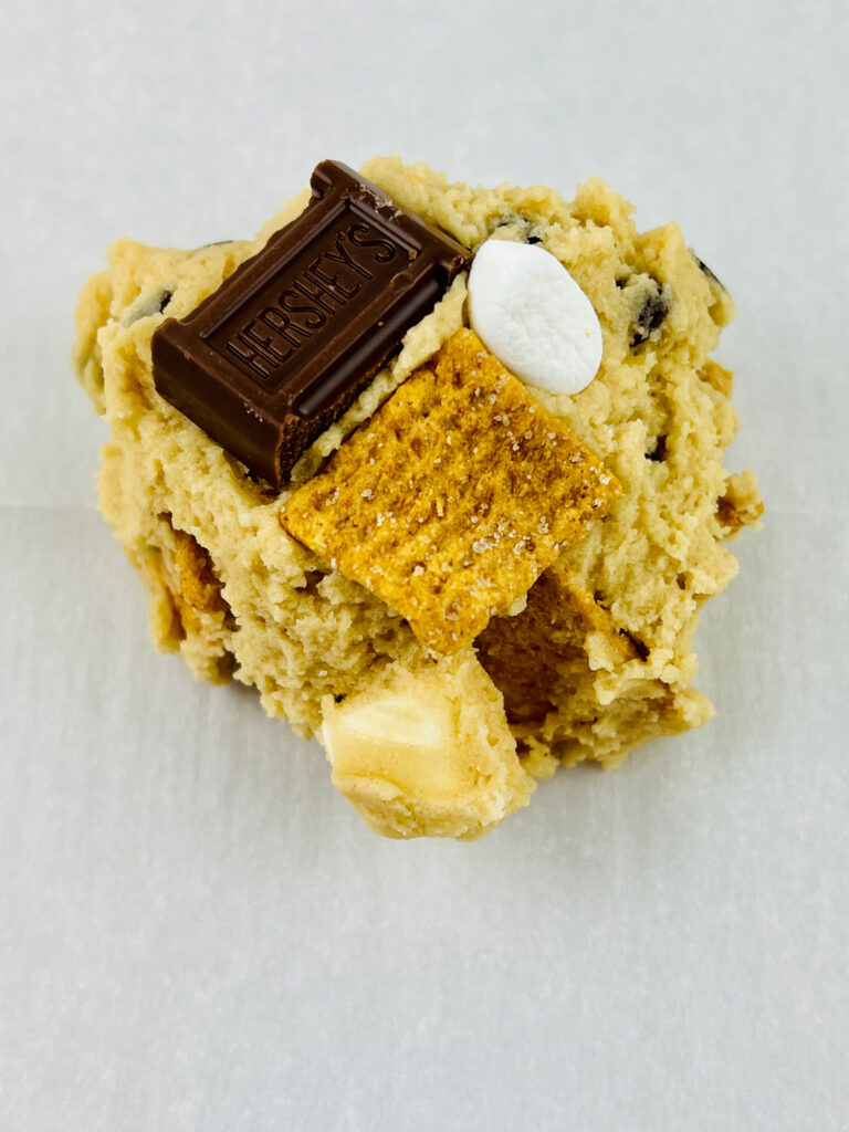 raw ultimate s'mores cookie on parchment paper