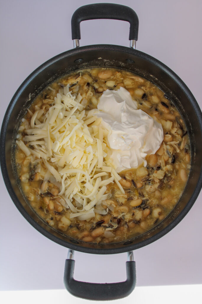 white chicken chili with hominy cooking in pot