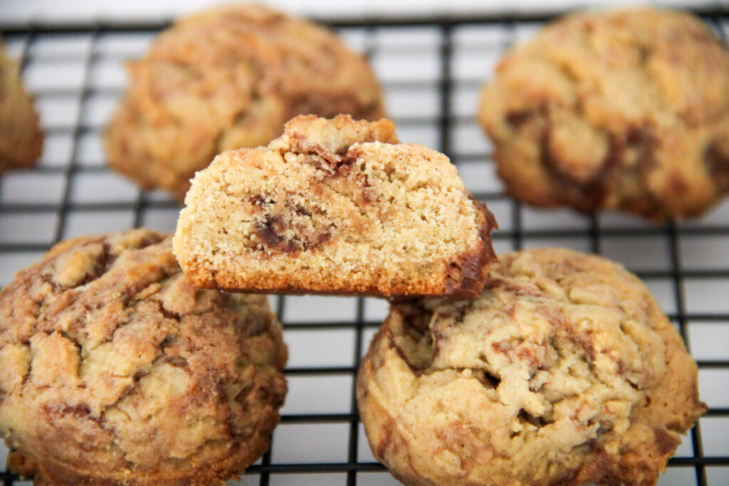 peanut butter Nutella cookies cooling on a black wire rack