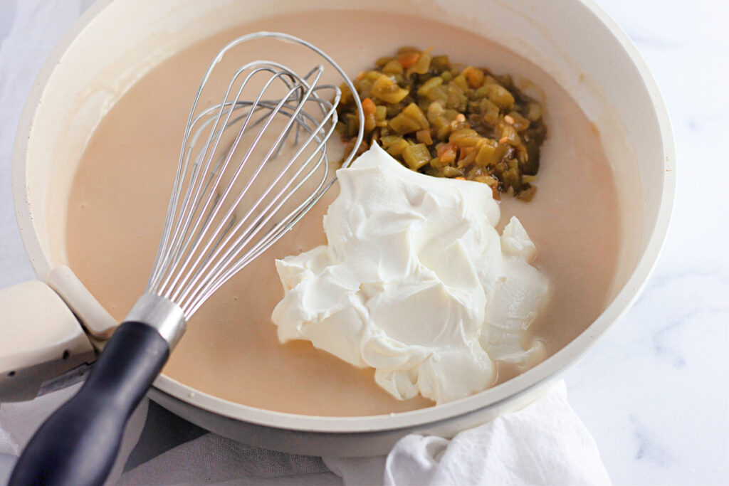 ingredients in a skillet with a whisk