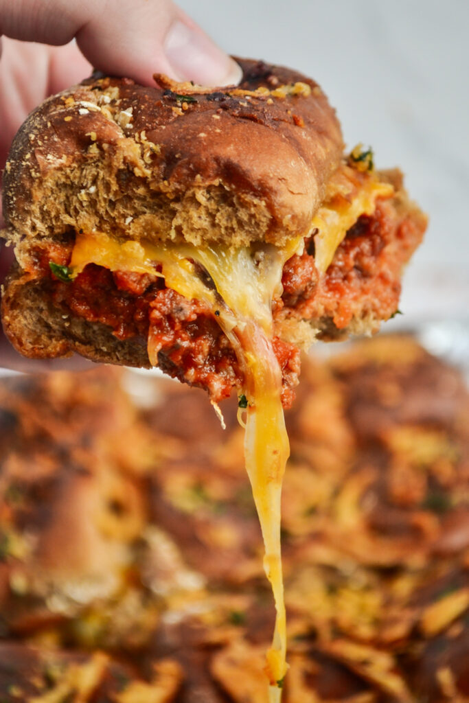 woman holds sloppy Joe sliders in her hand
